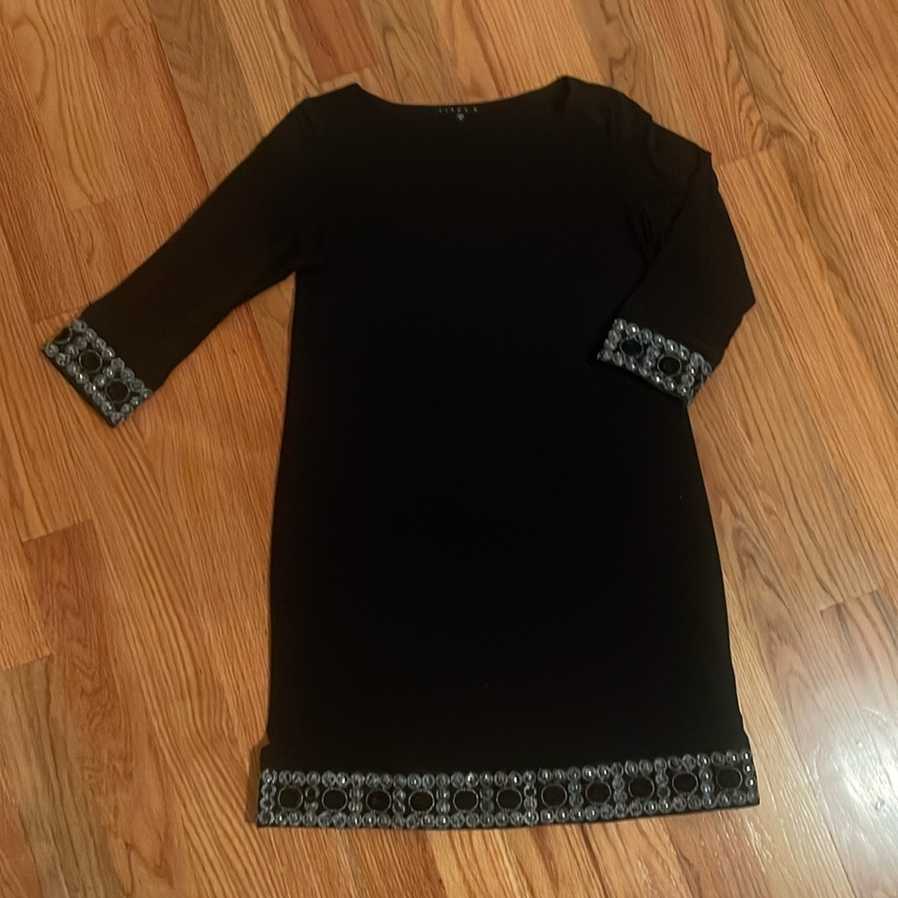 Black midi dress with beautiful embellishments on sleeves and bottom of skirt